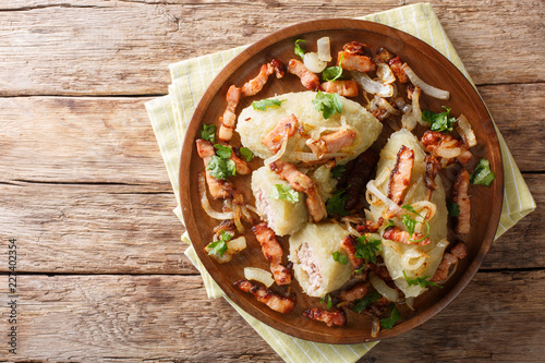 Cepelinai zeppelins or didzkukuliai is a traditional Lithuanian dish of stuffed potato dumplings close-up. Horizontal top view