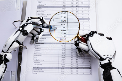 Robotic Hand Examining Financial Data