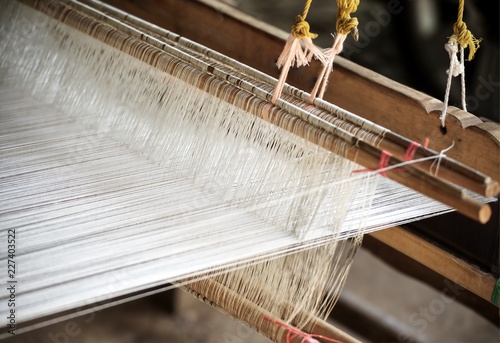 Close up cotton weaving on manual wood loom : Asian traditional culture