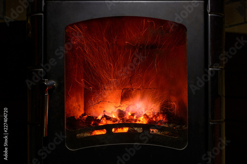drawing of sparks in a burning fireplace. the warmth and comfort of a home fireplace