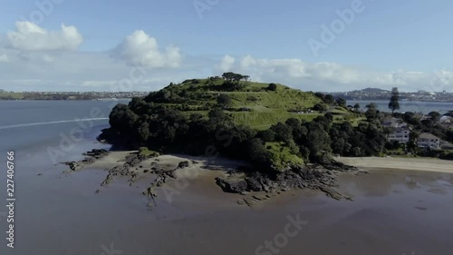 A fly forward drone shot towards one of the hills in Devenport in Auckland named North Head. It is a popular view point that reveals a nice panorama view over the area photo