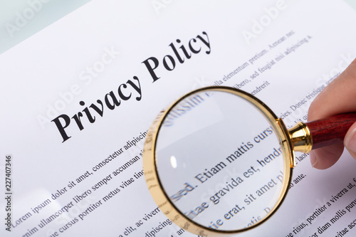 Woman Holding Pen Over Privacy Policy Form