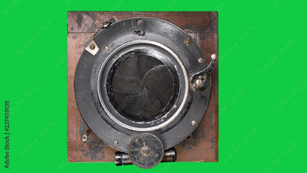 Vintage camera shutter opening and closing on green screen background