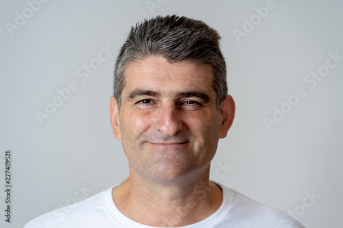 Close up portrait of a smiling and laughing mature man in happy face human emotions and expressions