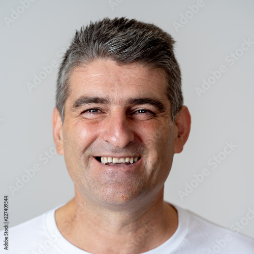 Close up portrait of a smiling and laughing mature man in happy face human emotions and expressions