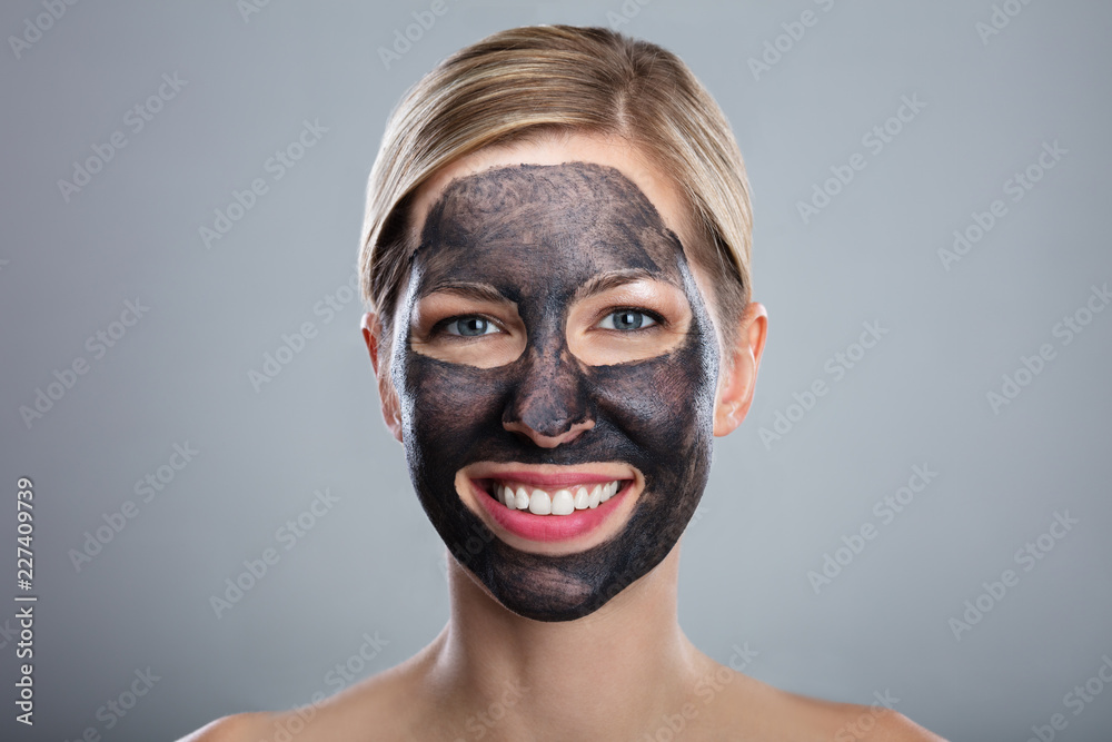 Smiling Young Woman With Activated Charcoal Face Mask Smiling Young Woman With Activated Charcoal Face Mask