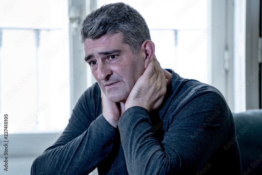 Depressed overwhelmed man feeling exhausted alone and unhappy
