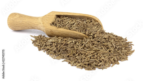 Cumin seed on wooden scoop isolated on white background