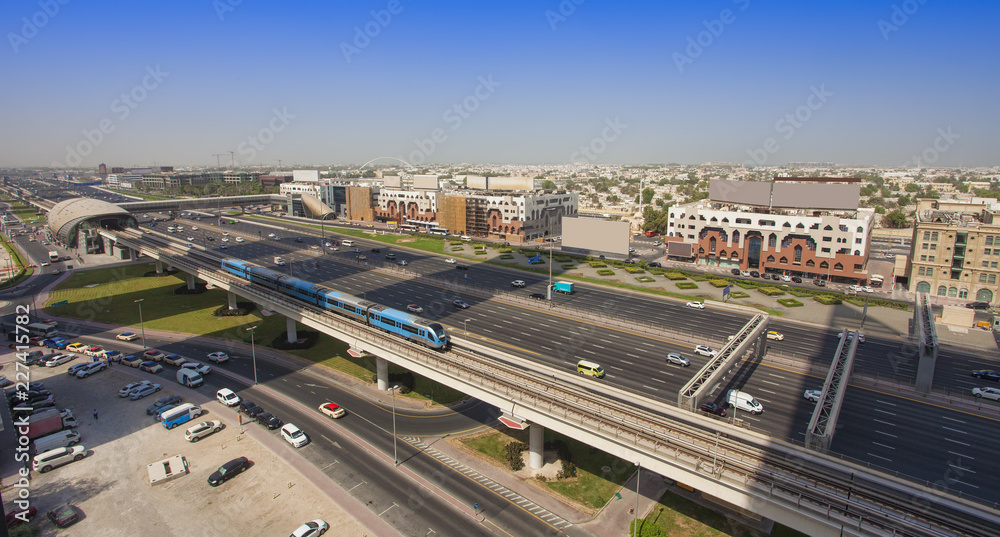 Dubai city street or road full of cars and metro. United Arab Emirates