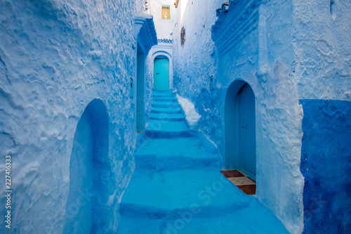 Narrow street and blue houses in Chefchaouen, Morocco