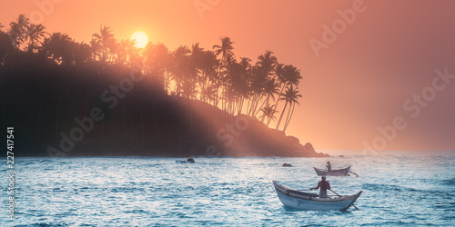 Fotografi Tropical beach on sunset with fishermen and sea