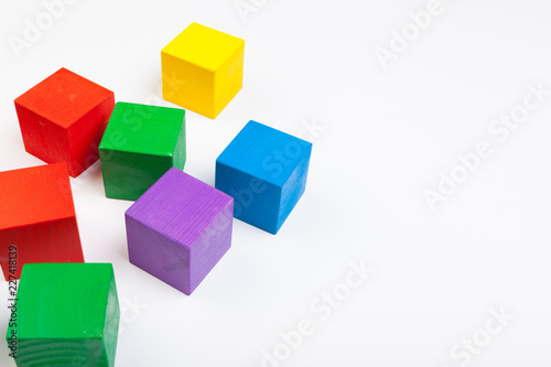 Colorful wooden building blocks isolated on white background © NewFabrika