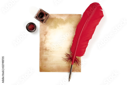 A vintage background with a vibrant red quill on a piece of old paper, with an ink well, on white with a place for text, top shot