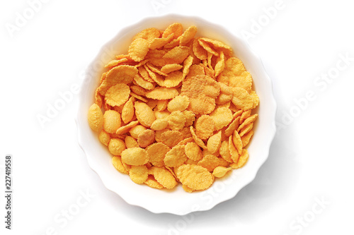 closeup of corn flakes in a white bowl isolated on white background, top view