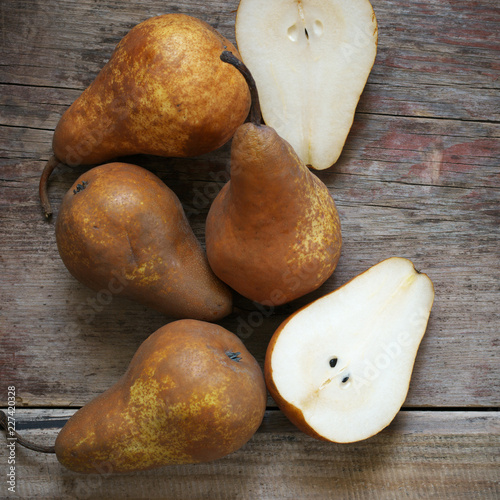 Brown pears on rustic wood