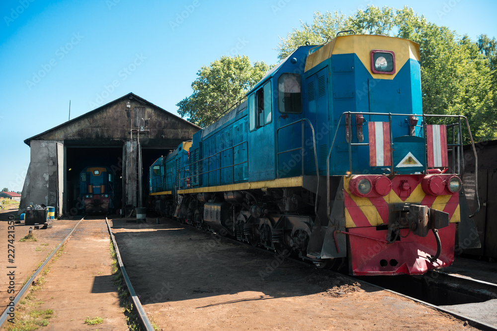 Old blue diesel locomotive leaves the depot. Railway transport Old blue diesel locomotive leaves the depot. Railway transport