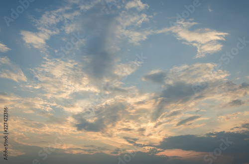 Yellow evening sunset in the sky with clouds