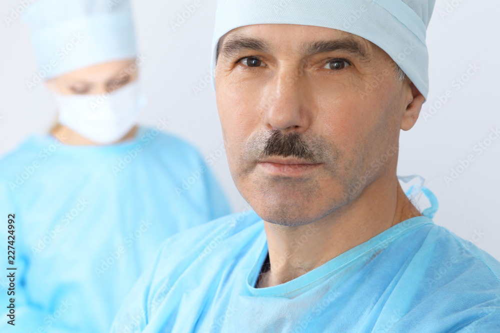 Boss surgeon is examining the operation while medical team are busy of patient. Medicine, healthcare and emergency in hospital Boss surgeon is examining the operation while medical team are busy of patient. Medicine, healthcare and emergency in hospital