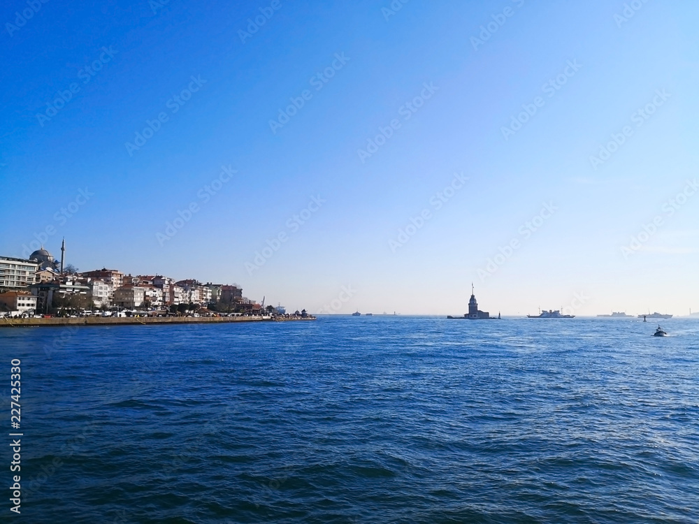 The Bosphorus Strait in Istanbul, Turkey-March 30, 2018: The Bosphorus Strait, adjacent to the Marmara sea, has the Maiden's tower or Leander's Tower on an islet off  the Asiatic shore.
