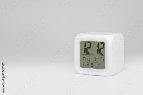 Modern alarm clock on white backdrops and copyspace. LED light or digital display.