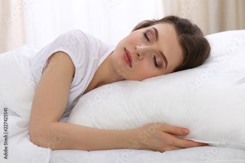 Beautiful young woman sleeping while lying in her bed. Concept of pleasant and rest reinstatement for active life