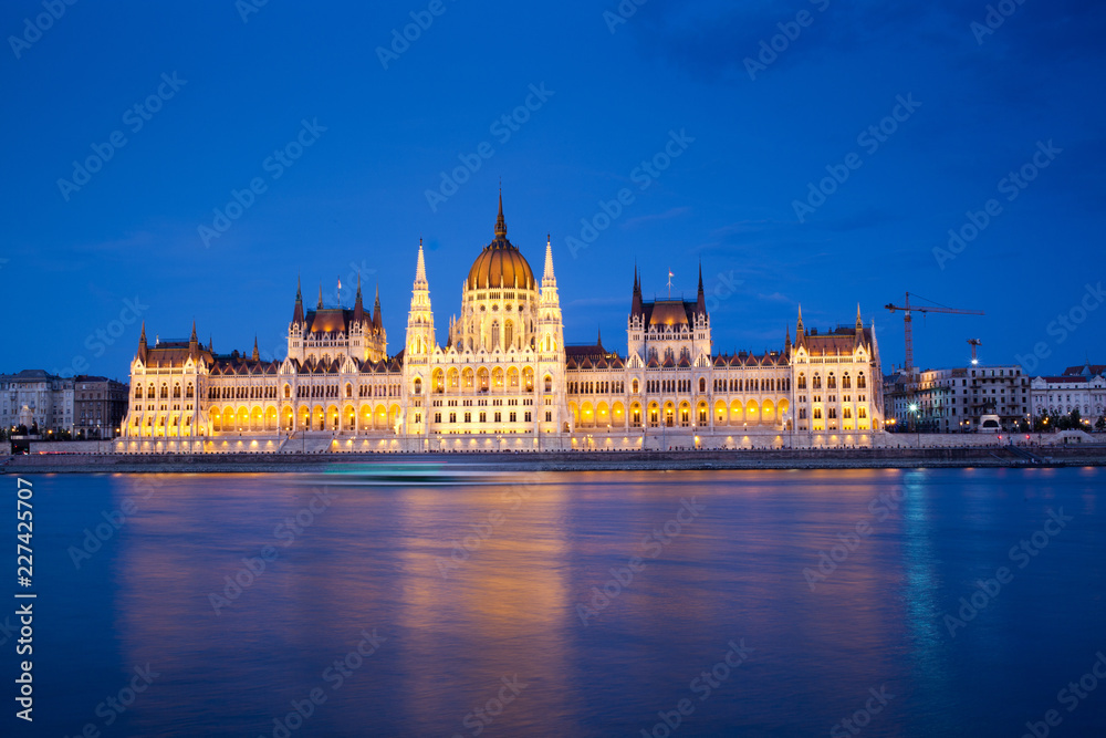 travel and european tourism concept. Budapest, Hungary. Hungarian Parliament Building over Danube River illuminated at night.