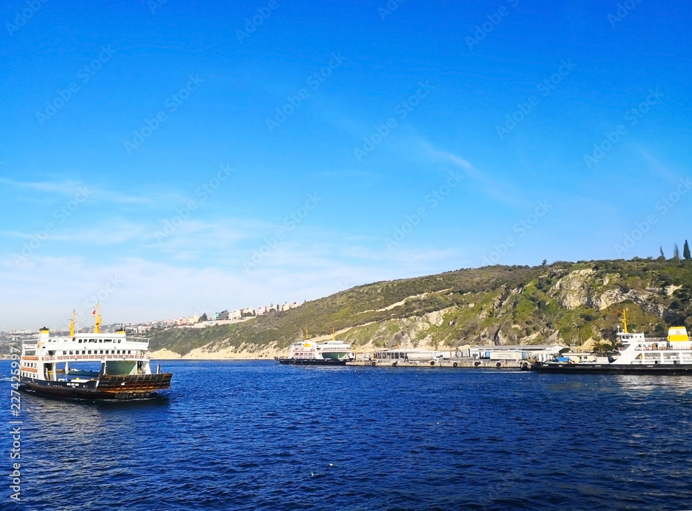 Natural and tourism concept. Many travel boats are sailing in the deep blue sea and the clear blue sky. Selective focus, background and copy space.