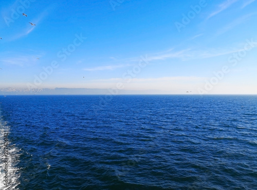 Travel and transportation concept. The wave hit the ship, causing a white bubble. As the ship is is traveling across the sea to another city. Selective focus and copy space.