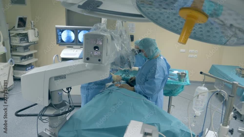 Medical workers performing a surgery using modern medical robot. Medical workers performing a surgery using modern medical robot.