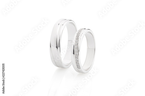 Pair of silver wedding rings with diamonds isolated on white background