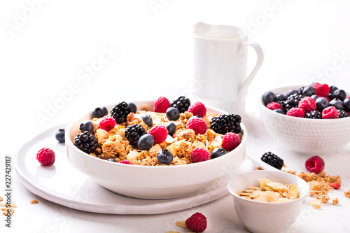 Granola Cereal bar with Strawberries blueberries and Milk on light Background . Muesli Breakfast. Healthy Food sweet dessert snack. Diet Nutrition Concept. Vegetarian food. Copy space for Text.