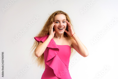 Studio portrait of a beautiful girl blonde teenager on a white background.