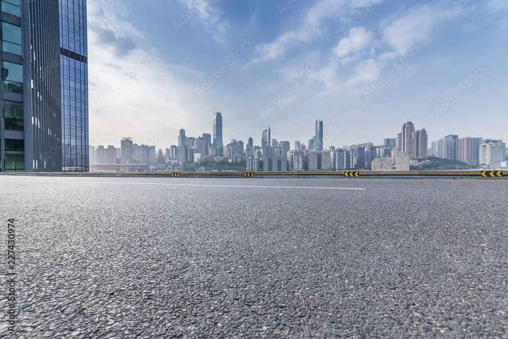 Panoramic skyline and modern business office buildings with empty road,empty concrete square floor Panoramic skyline and modern business office buildings with empty road,empty concrete square floor