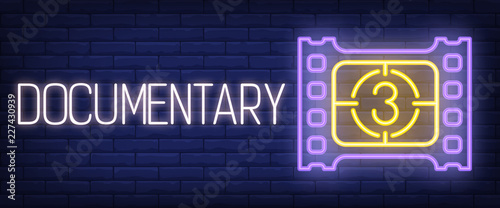 Documentary neon sign. Film strip and countdown on brick wall background. Vector illustration in neon style for movie watching and cinema