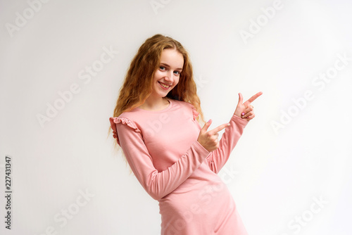 Studio portrait of a beautiful girl blonde teenager on a white background.