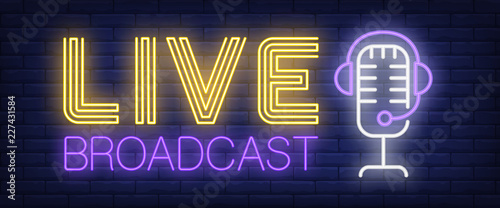 Live broadcast neon sign. Headset and mic on brick wall background. Vector illustration in neon style for radio station