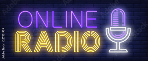 Online radio neon sign. Microphone on brick wall background. Vector illustration in neon style for radio station and broadcasting