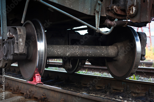 red railway brake shoe under the train wheel