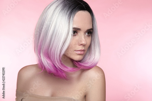 Ombre bob short hairstyle. Beautiful hair coloring woman. Trendy puprle haircut. Blond model with short shiny haircuts isolated on pink Background. Makeup. Beauty Salon.