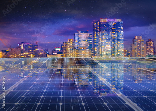 Solar panel over cityscape nightlight background. solar power green energy for life concept 