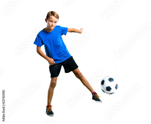 Fototapeta Naklejka Na Ścianę i Meble -  A full-length shot of Boy playing soccer kicking the ball on isolated white background