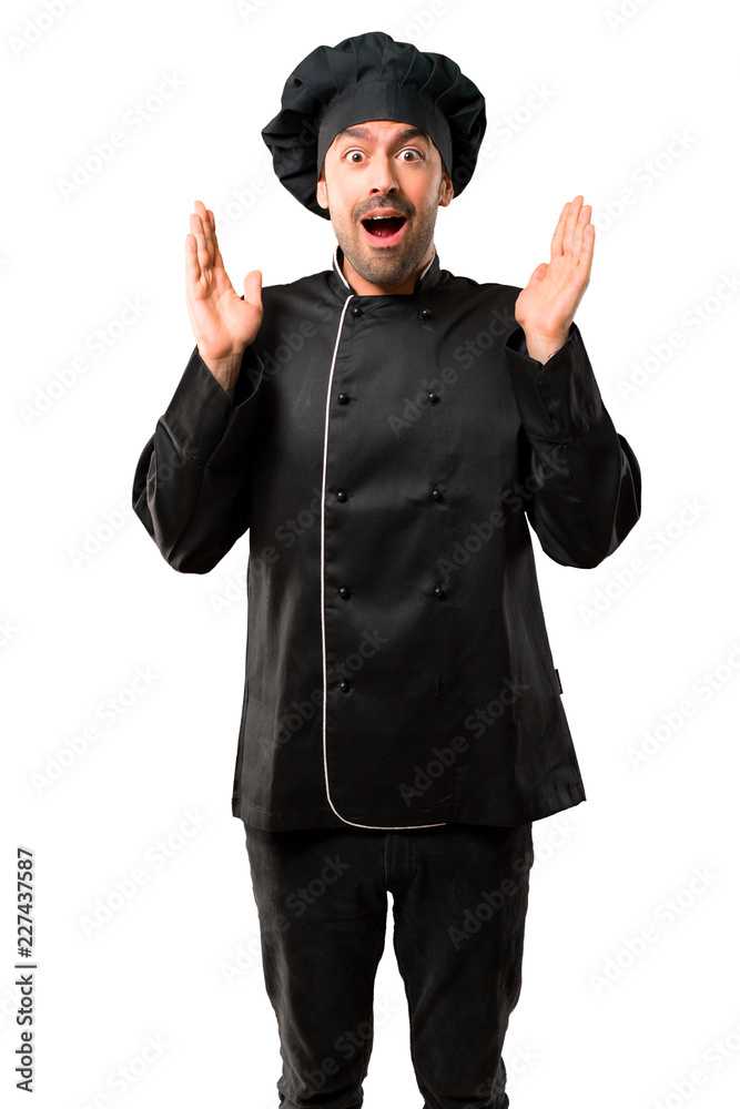 Chef man In black uniform with surprise and shocked facial expression. Mouth open because not expect what has happened on isolated white background Chef man In black uniform with surprise and shocked facial expression. Mouth open because not expect what has happened on isolated white background