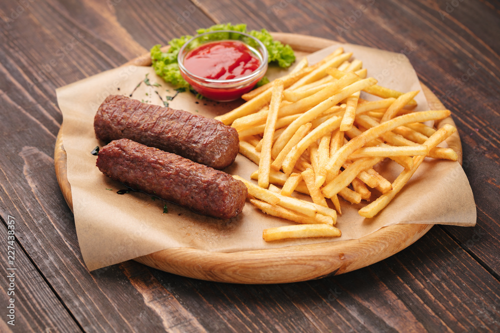 Traditional moldavian grilled sausages served on a wooden tray
