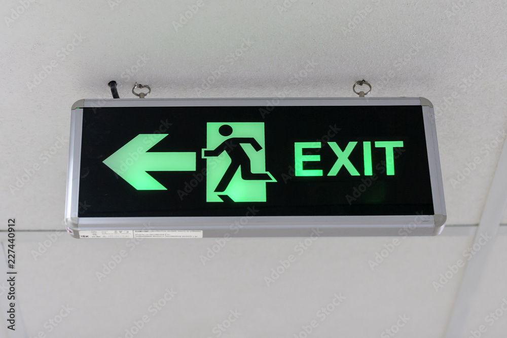 Fire exit sign at the corridor in building. Fire exit sign at the corridor in building.