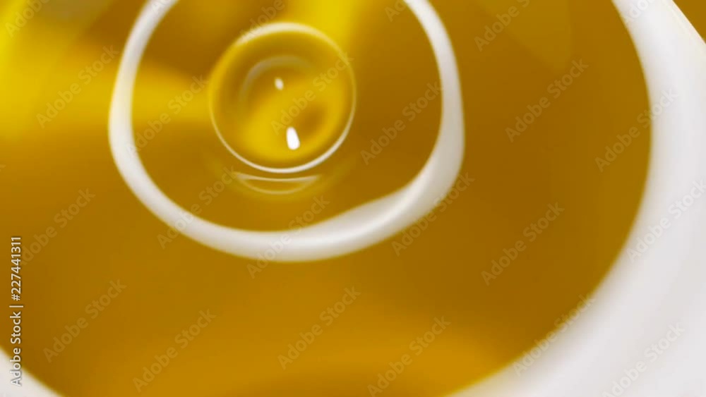 Drops of oil falling in pond and making ripple.
