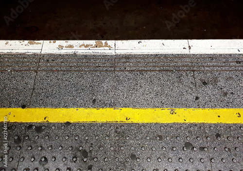 Stand behind the yellow line warning sign, London 