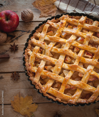 Homemade apple pie on wooden background, top view