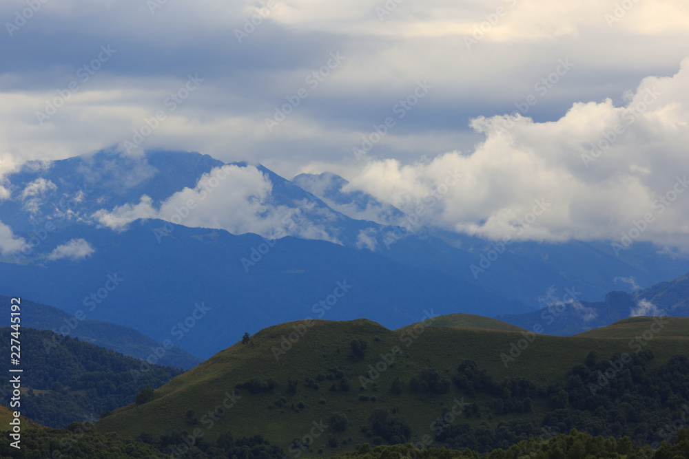 Clouds over the hills in the area of Mount Elbrus. Photographed in the Caucasus, Russia.