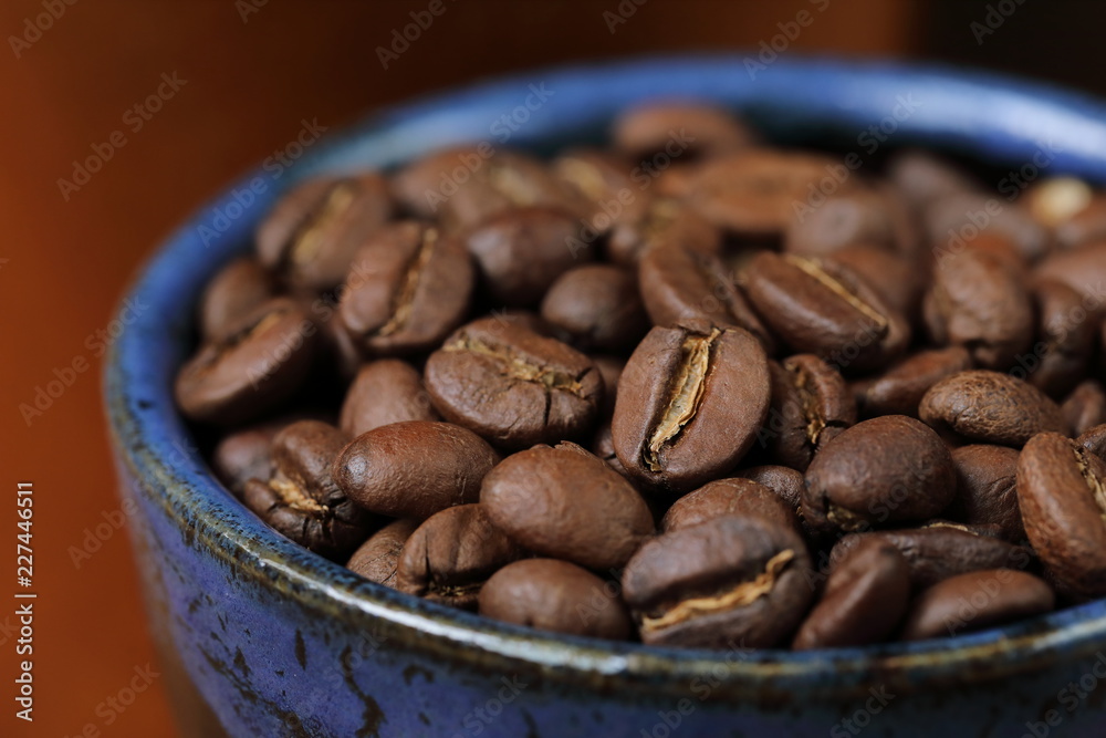 coffee beans in cup on wooden background coffee beans in cup on wooden background