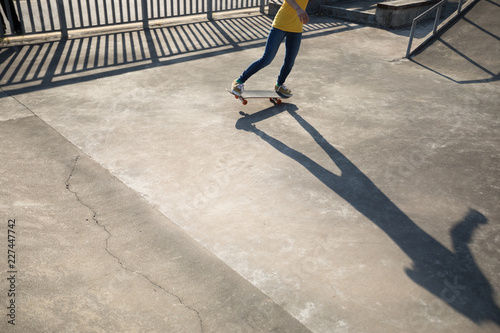 Skateboarder doing ollie at skatepark